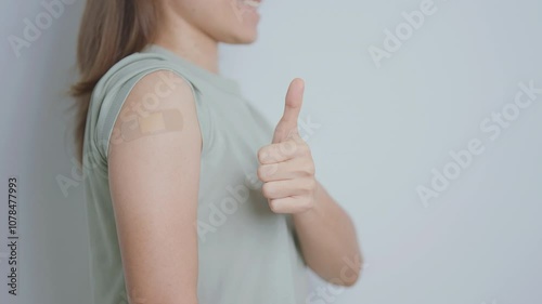 Woman with bandage after receiving vaccine. Vaccination and Immunization for Influenza, HPV, Zoster, IPD, DTP or Diphtheria, Tetanus and Pertussis, MMR, Hepatitis B, Covid  and Varicella vaccine photo