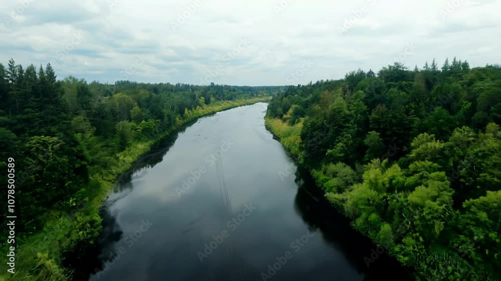 Aerial view of a calm river flowing through a green forest. Aerial view of a calm river flowing through a green forest.