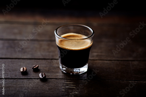 Coffee in glass cup on dark background. Close up. Copy space.