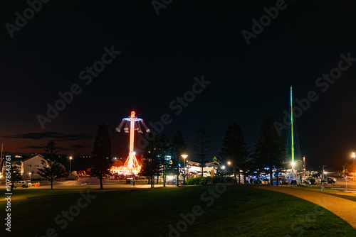 Newcastle skyline illuminated by vibrant carnival rides at night photo