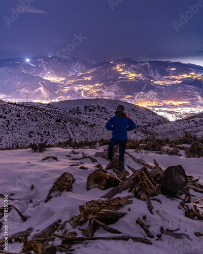 Man Standing On Winter Night Hike In the Mountains Above Avon Colorado and Beaver Creek Ski Resort 