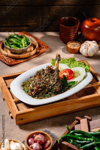 Bebek goreng cabe ijo or fried duck with green chili sauce.