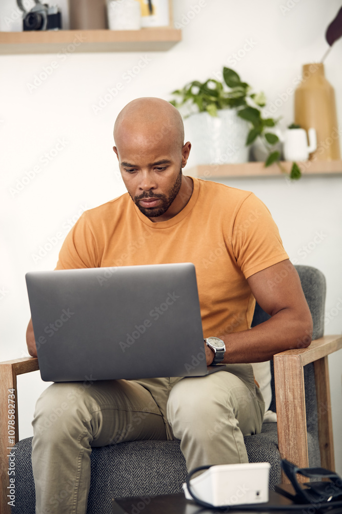 Laptop, remote work and research with freelance man in living room of home for report or typing. Computer, email and networking with entrepreneur employee in apartment for small business startup Laptop, remote work and research with freelance man in living room of home for report or typing. Computer, email and networking with entrepreneur employee in apartment for small business startup
