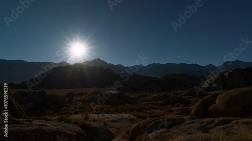 Timelapse transition from moonset to sunrise over Sierra Nevada Mountains in California, USA