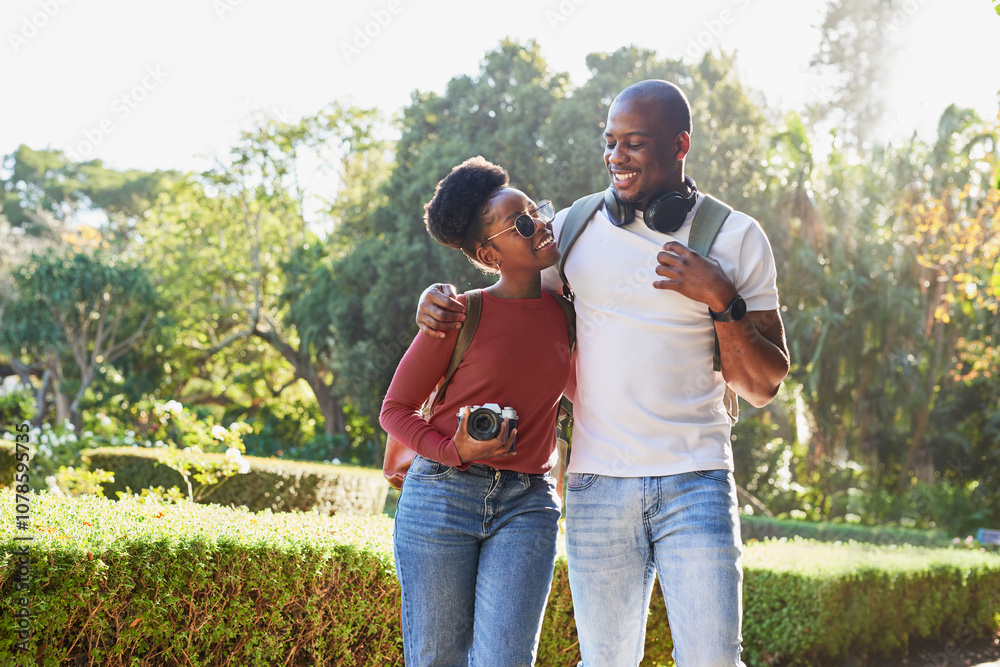 Joyful Couple Enjoying a Sunny Walk in the City Park Holding Cameras and Listening to Music Joyful Couple Enjoying a Sunny Walk in the City Park Holding Cameras and Listening to Music