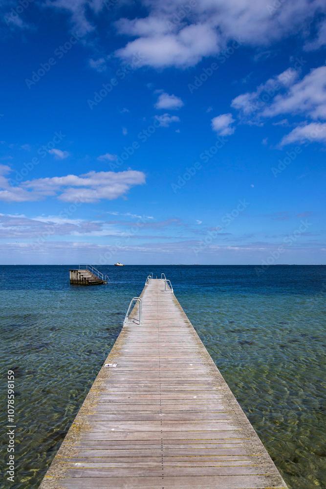 Empty wooden pier for swimming and hardening in the sea, Copenhagen, Denmark, sunny day, blue sky copy space