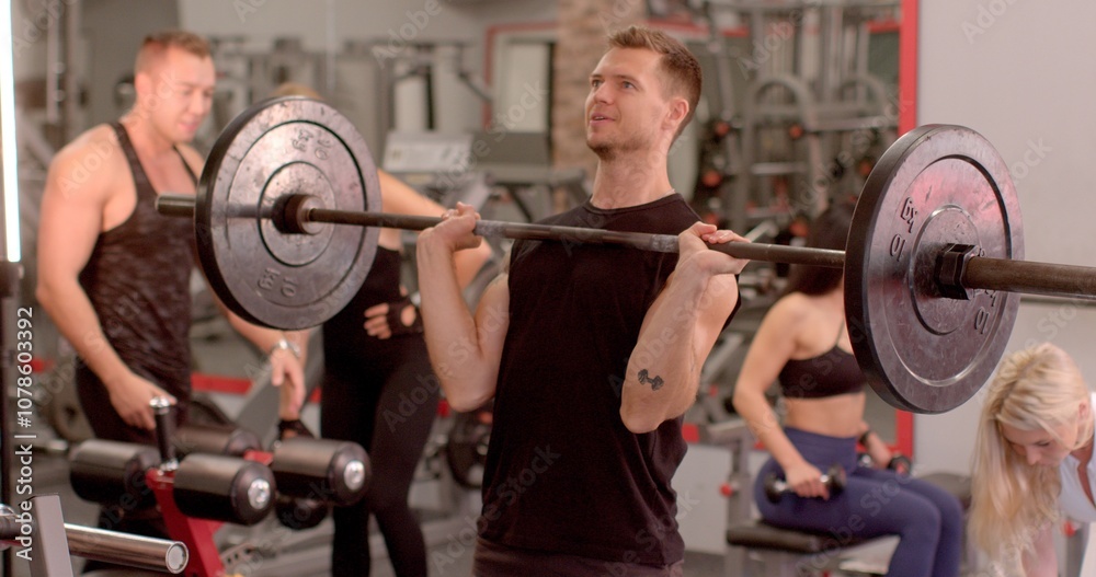 Sport enthusiasts actively engage in a wide variety of exercises within a vibrant and dynamic gym setting He lifts the barbell, she lifts the kettlebell. Sport enthusiasts actively engage in a wide variety of exercises within a vibrant and dynamic gym setting He lifts the barbell, she lifts the kettlebell.