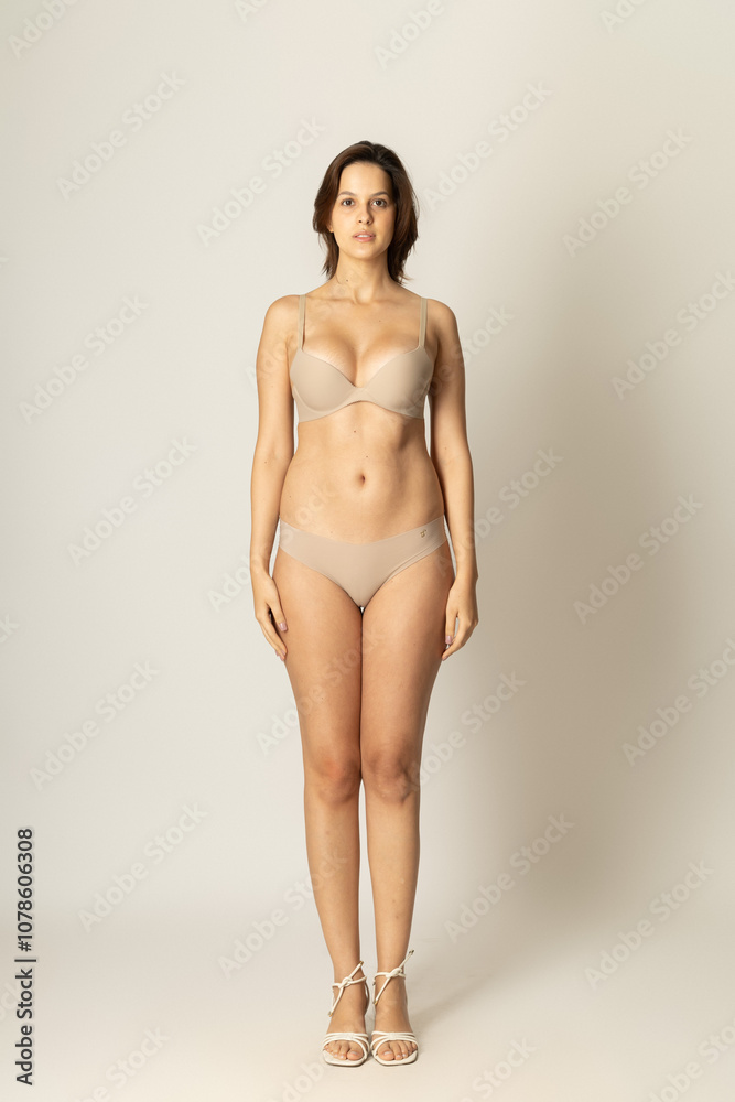 Fototapeta premium Confident Studio Portrait of a Stylish Woman Model – Professional Fashion Shoot with Natural Poses, Expressive Look, Clean Background – Diversity, Beauty, Elegance, Authentic Presence