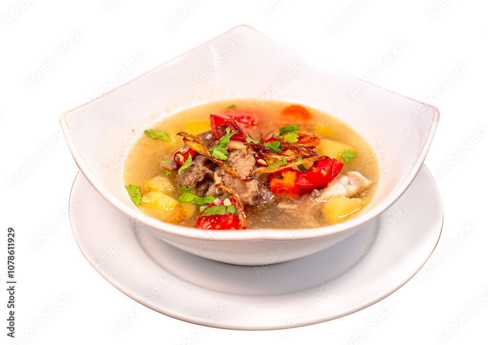 Hot lamb soup with fried onion and celery leaves. Mixed with potatoes, carrots and fresh red tomato slices. Isolated on white background Hot lamb soup with fried onion and celery leaves. Mixed with potatoes, carrots and fresh red tomato slices. Isolated on white background