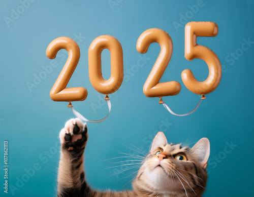 Playful tabby cat holding golden balloons forming number 2025 against a vibrant teal background, celebrating the upcoming new year