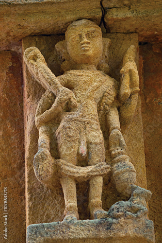 Carved sculpture of a Hindu deity on the Vishwanatha Shiv Temple, located in Karimati, Umaria, Madhya Pradesh photo