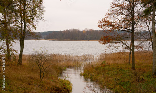 Beautiful lake in autumn, a stream flowing into it