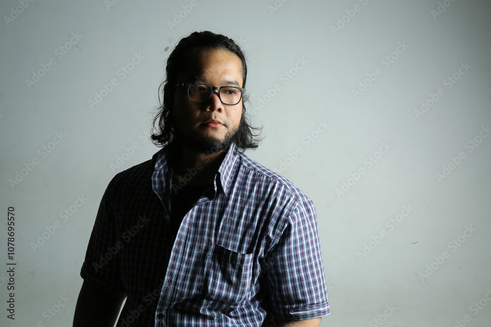 portrait of serious facial expressions of Asian men using low light photography techniques portrait of serious facial expressions of Asian men using low light photography techniques