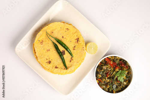 Makai roti with Sarson ka saag, also known as sarsa da saag, is a dish of mustard greens cooked with spices. It originated in the Punjab region and is popular throughout the South Asia. photo