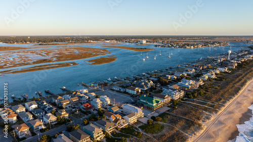 Aerial view of Wrightsville Beach, NC, featuring beachside residential homes along the coastline, highlighting issues related to climate change, flooding, and hurricane risk in coastal real estate.