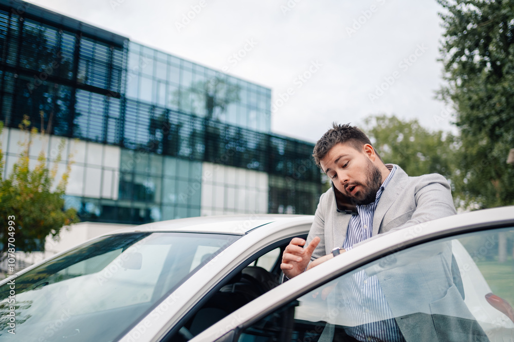 Stressed businessman running late checking time on wristwatch Stressed businessman running late checking time on wristwatch