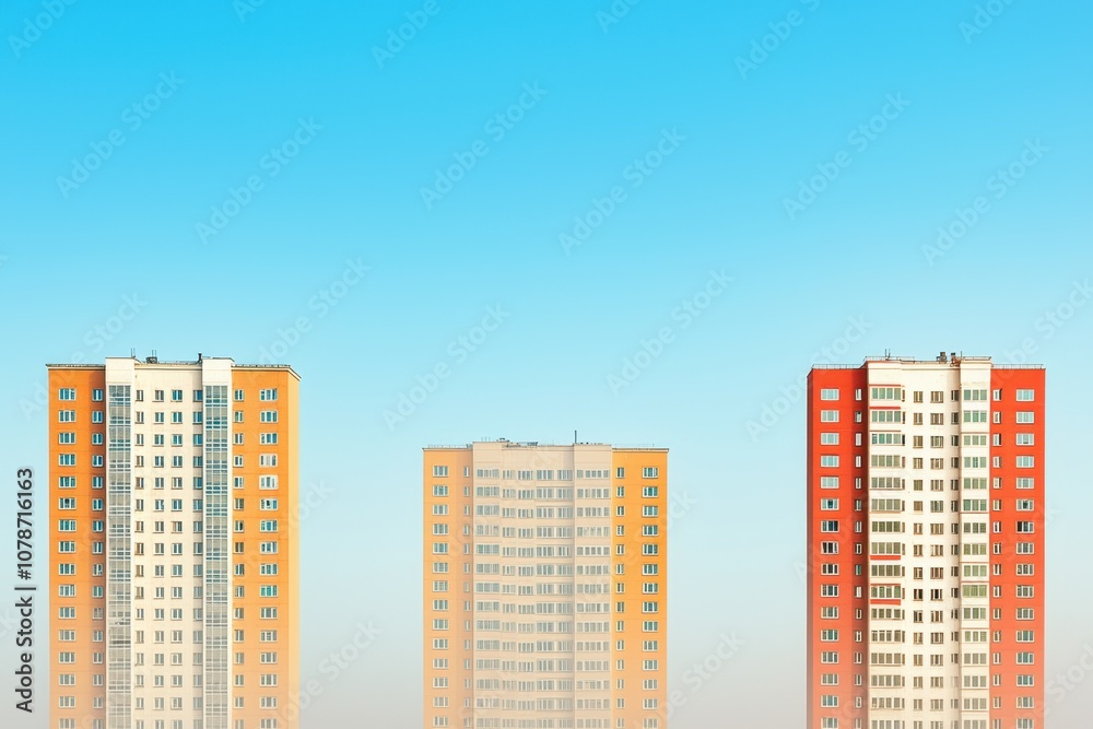 Modern high-rise buildings stand against clear sky