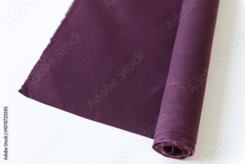 roll of waxed canvas fabric, purple or burgundi color photo