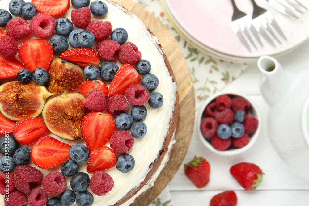 Delicious chocolate sponge cake with berries served on white wooden table, top view Delicious chocolate sponge cake with berries served on white wooden table, top view