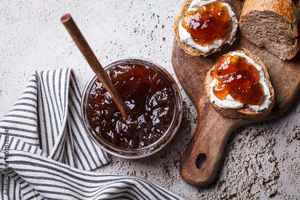 Fototapeta premium Onion jam on toast with cream cheese, gray background.