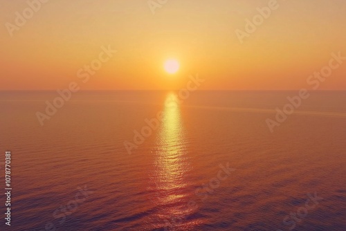 Golden hour over the ocean, the sun casts a warm glow on the rippling water.