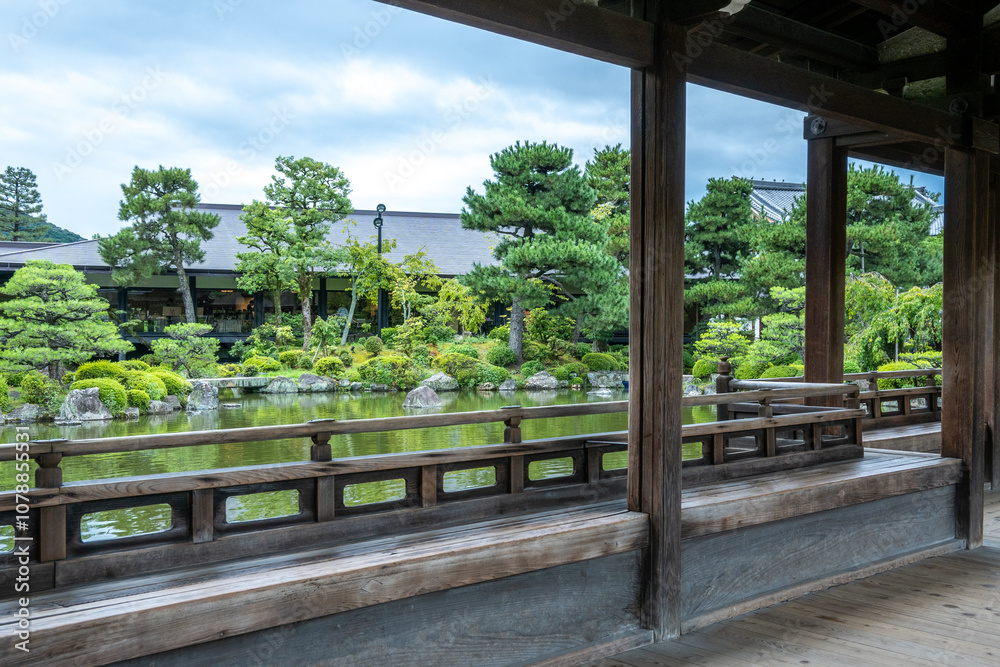 Wooden veranda overlooking tranquil japanese garden with pond Wooden veranda overlooking tranquil japanese garden with pond