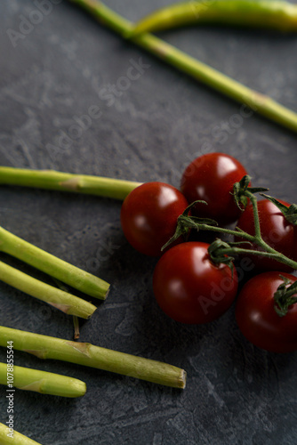 a branch of cherry tomatoes on a dark background