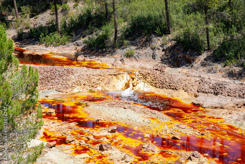 Rio Tinto river and iron mines. Red tinted river by copper, iron on the ground. Water used in life study for life detection in Mars. photo