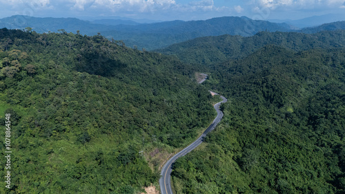 Road number three, Nan Province, aerial view of a beautiful road through the mountains full of green trees. Travel concept, transportation concept.