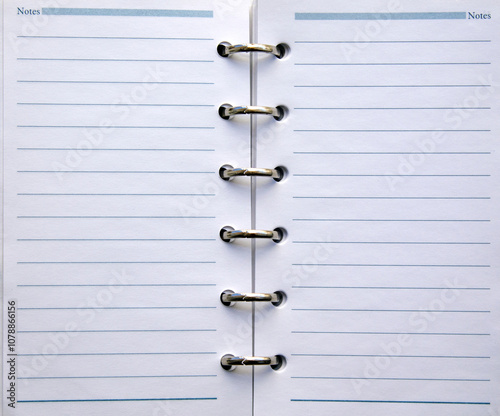 close up  of an open daily calendar with silver rings. top view