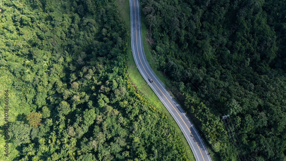 Road number three, Nan Province, aerial view of a beautiful road through the mountains full of green trees. Travel concept, transportation concept.