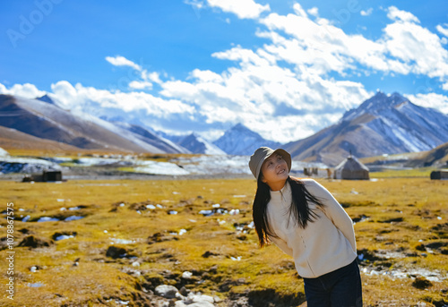 Asian woman enjoying beautiful autumn landscape of Bayanbulak Grassland along Duku Highway(Rd. G217), Korla, Xinjiang, China photo