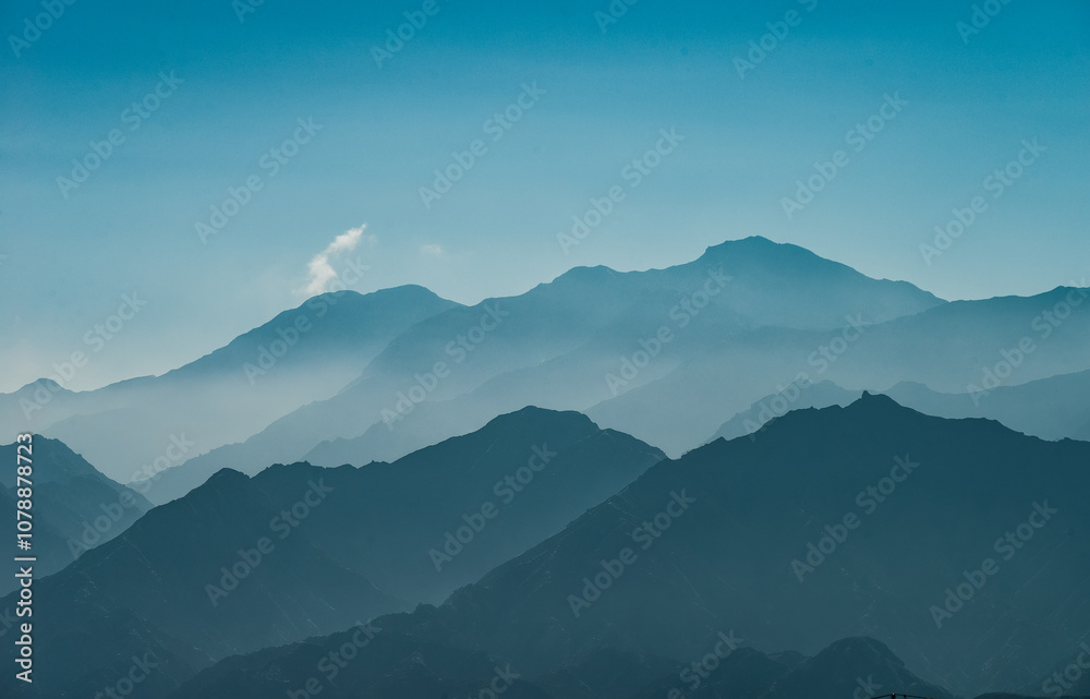 beautiful landscape of Tianshan Mountains silhouette in the morning in autumn season along Duku Highway(Rd. G217) at Kuche, Xinjiang, China beautiful landscape of Tianshan Mountains silhouette in the morning in autumn season along Duku Highway(Rd. G217) at Kuche, Xinjiang, China