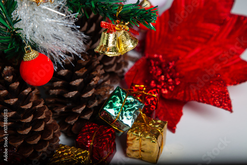 Decoration details of a Christmas tree decorated in red and gold.