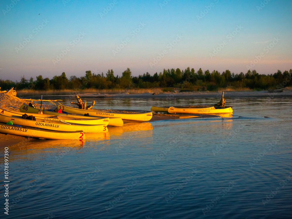 Fototapeta premium Fishing boats at the mouth of the Gauja River at sunset, Latvia