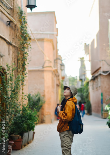 A Chinese woman sightseeing in the old streets of the ancient city of Kashgar, Xinjiang, China