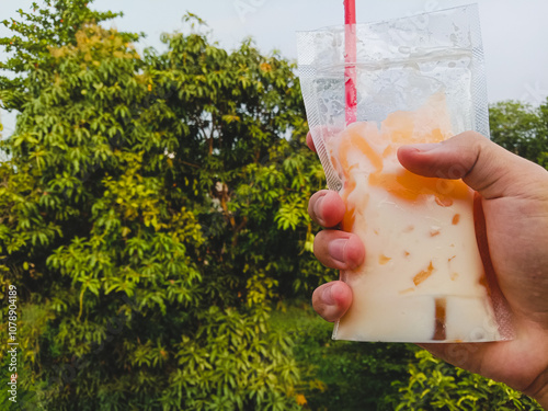 Mango pudding with vla is served in a plastic bag and eaten like drinking water, by siphoning. photo