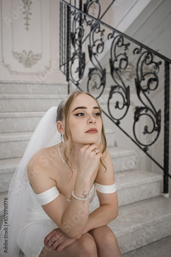 Young blonde girl is getting married. White dress and veil.