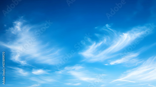 A Vivid Blue Sky with Wispy White Clouds Drifting Across, Creating a Serene and Tranquil Atmosphere, Ideal for Backgrounds and Designs