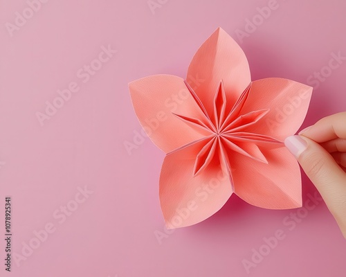 Delicate origami paper flower being folded, instructional diagrams clearly visible, flower origami folding, stepbystep guidance photo