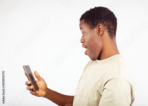 A young man using a smartphone. Ideal for themes of communication, technology, and modern lifestyle.