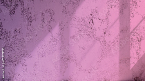 Textured pink wall background with subtle details and imperfections. pink wall texture. Textured pink wall with a rough surface illuminated softly, simple and abstract.