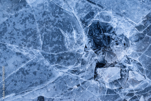 Cracked and broken ice background texture. Frozen lake ice. Ice surface.