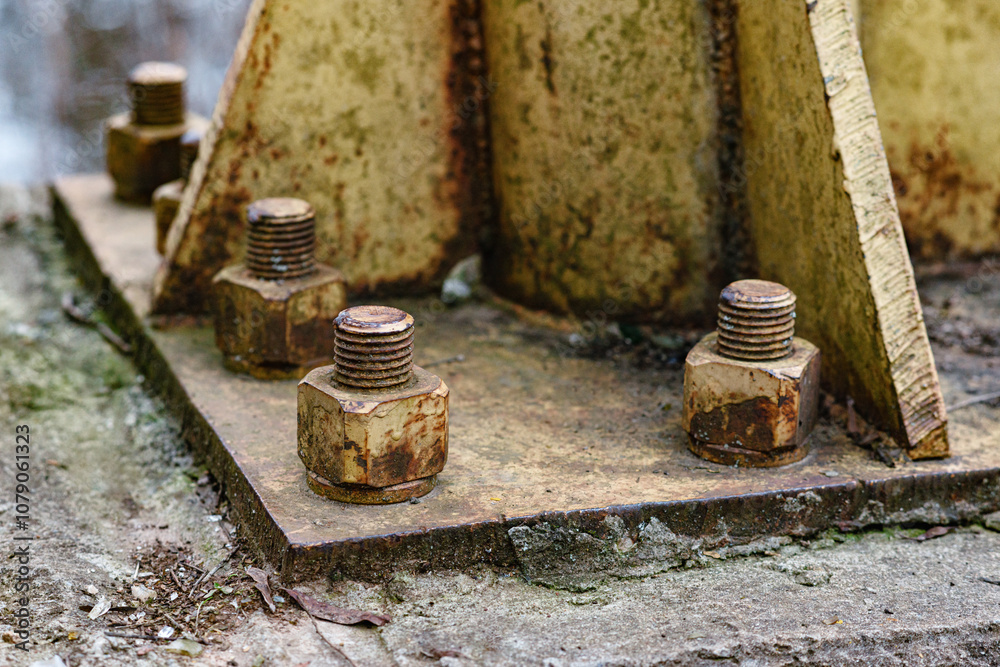 Steel bolt nut attaches the steel plate to the cement column. Rusty nut and washer on steel structure. corrosion of steel. bolt and nut on metal. Steel bolt nut attaches the steel plate to the cement column. Rusty nut and washer on steel structure. corrosion of steel. bolt and nut on metal.