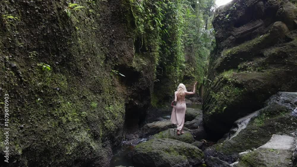 Blonde Woman Exploring Ancient Jungle Pathway in Mystical Stone Canyon. Blonde Woman Exploring Ancient Jungle Pathway in Mystical Stone Canyon.