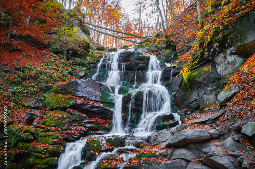 Beautiful autumn landscape with yellow trees and mountain waterfall