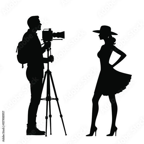A silhouette of a cameraman operating a standing camera on a tripod,