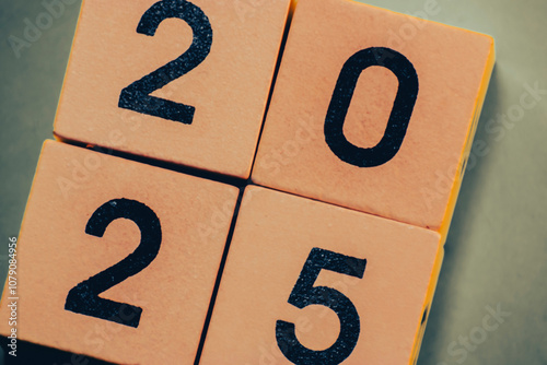 2025 new year number on wooden calendar cubes grey green background 