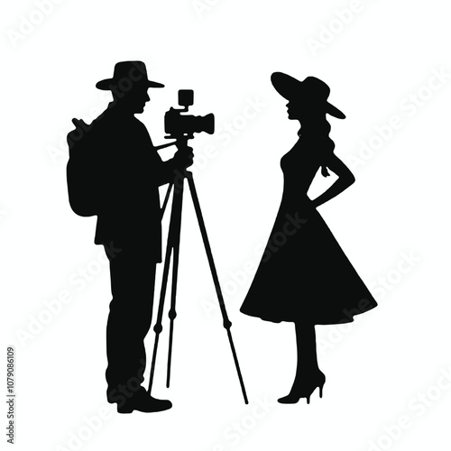 A silhouette of a cameraman operating a standing camera on a tripod,