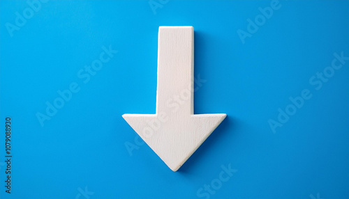 White wooden arrow pointing down on blue background. Business, market decline or economic.
